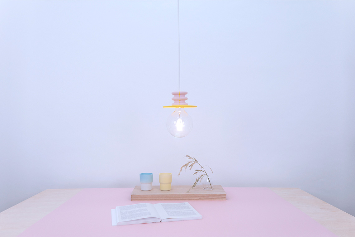 Frutti bright pendant light with pink and yellow stone base with large LED E26 bulb.