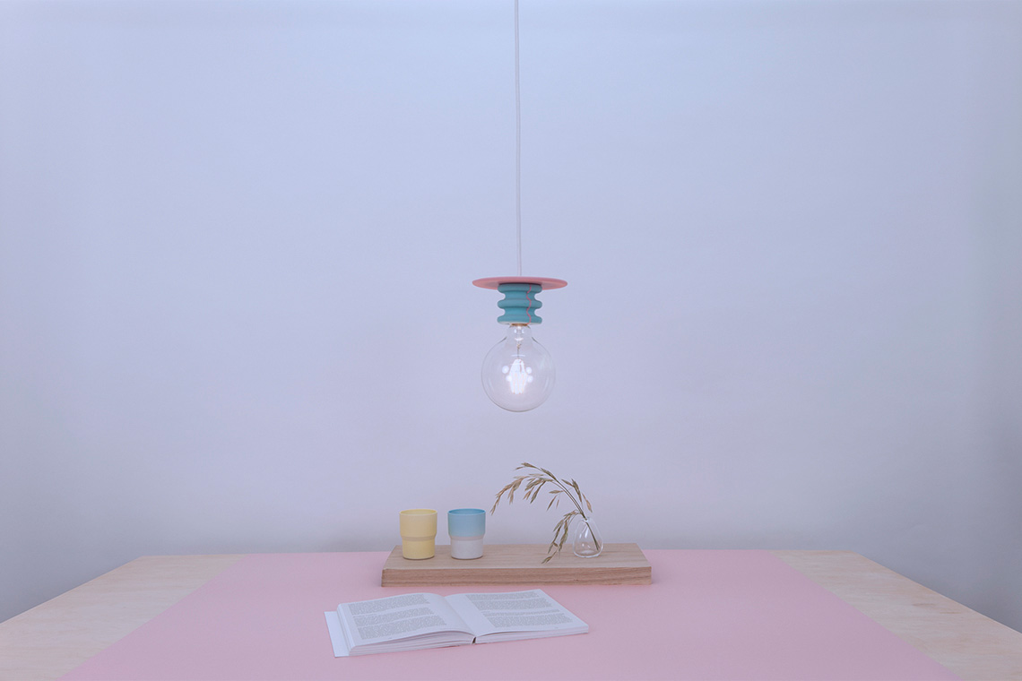 Cyon and pink Frutti ceiling lamp over a dining table setting